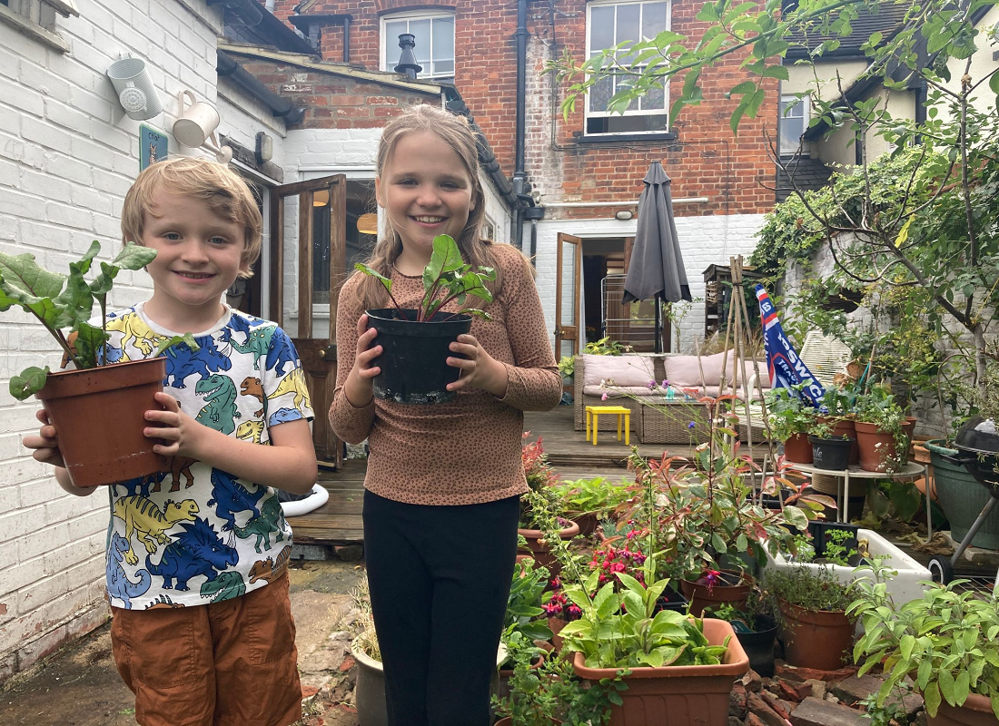 Children showing their plants in the garden